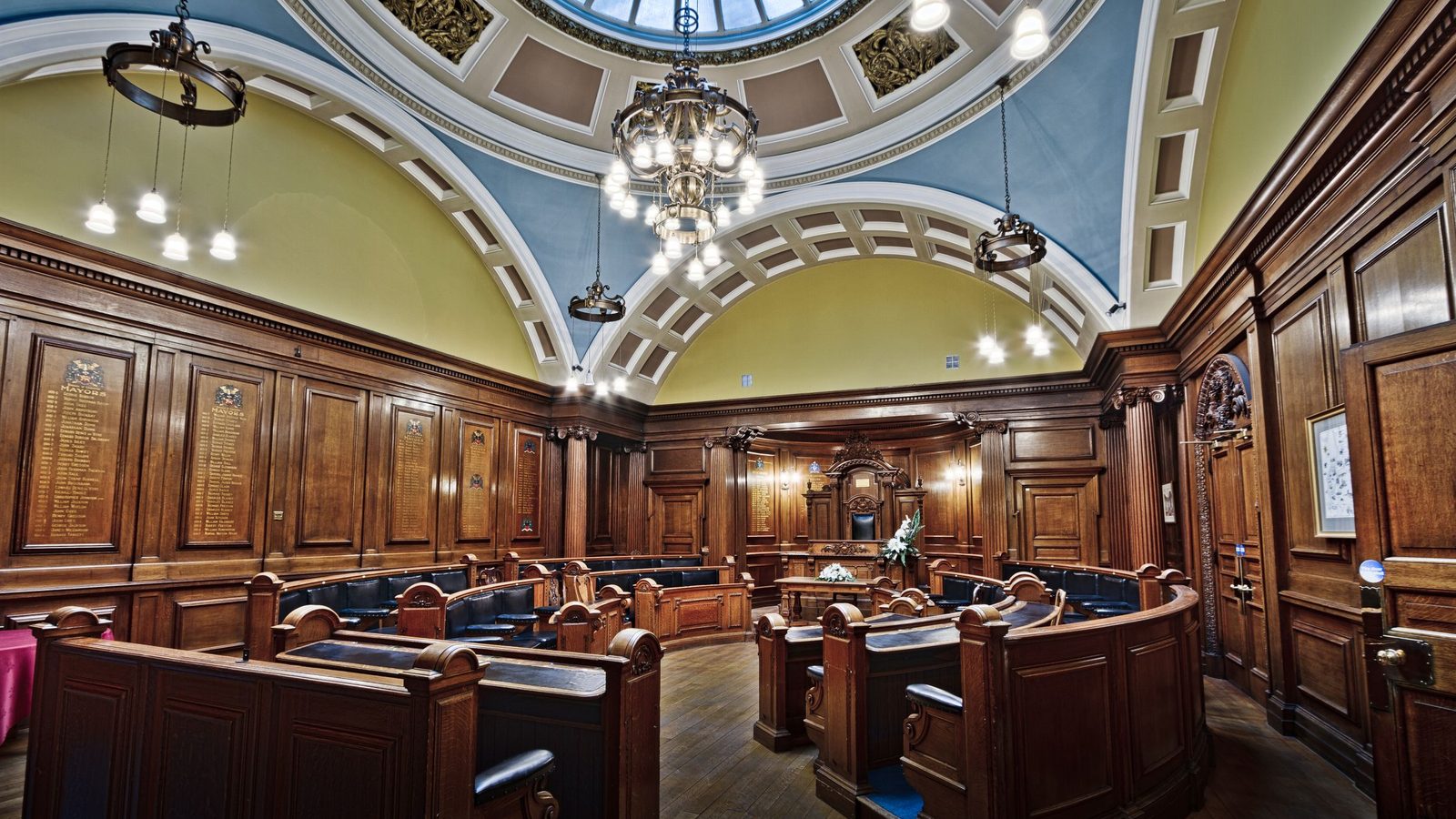 Public sector professionals reviewing contract performance documents in a modern civic building